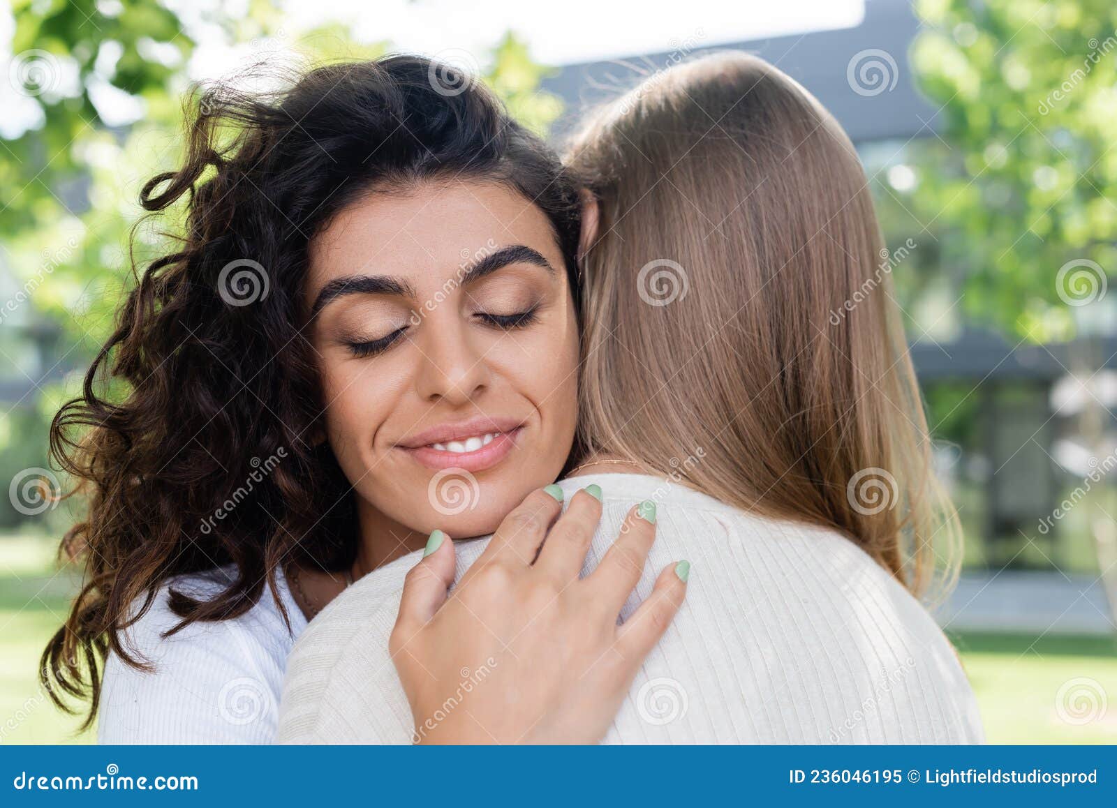 Pleased And Curly Woman Hugging Girlfriend Stock Image Image Of Homosexuality Lgbt 236046195