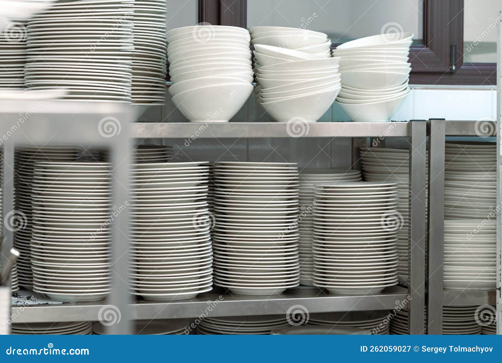 Plenty of Stacked Plates in the Kitchen Cupboard Close Up Stock Image