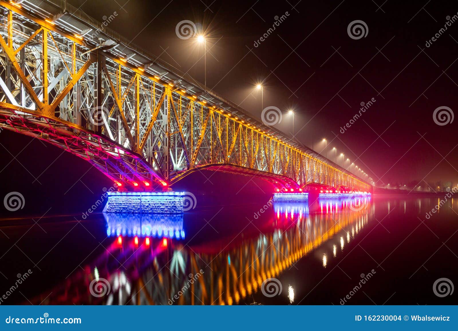 plock, poland - road-railway bridge over the vistula wisla river in illuminated at night