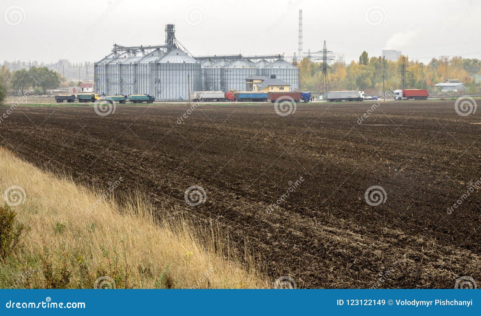 Plowed Field in Front of the Elevator for Grain Storage. Grain