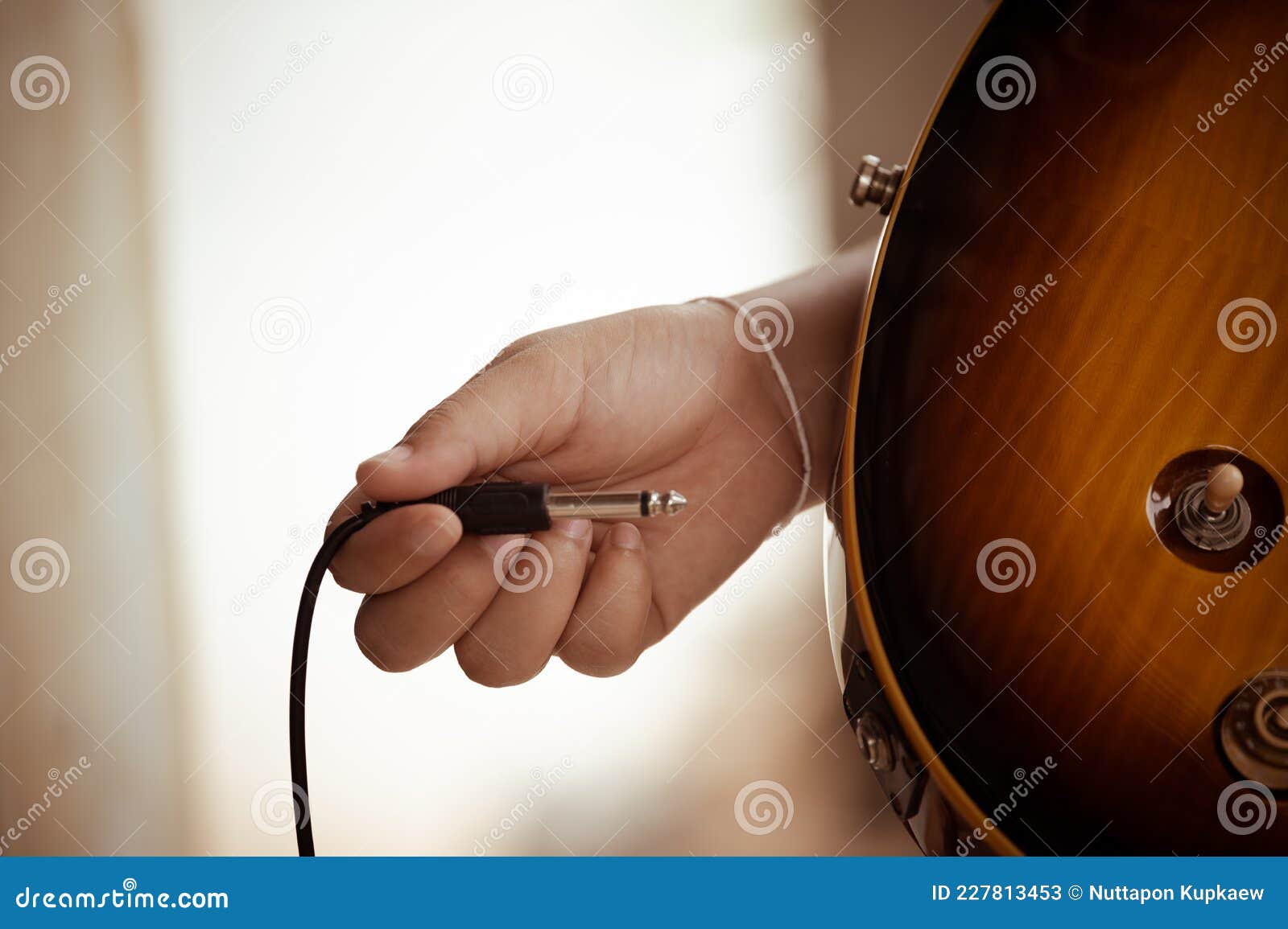 Plug Jack Cable in Electric Guitar,Hand Inserts Input Jack To Electric