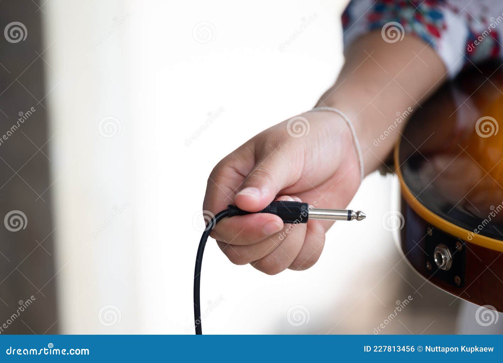 Plug Jack Cable in Electric Guitar,Hand Inserts Input Jack To Electric