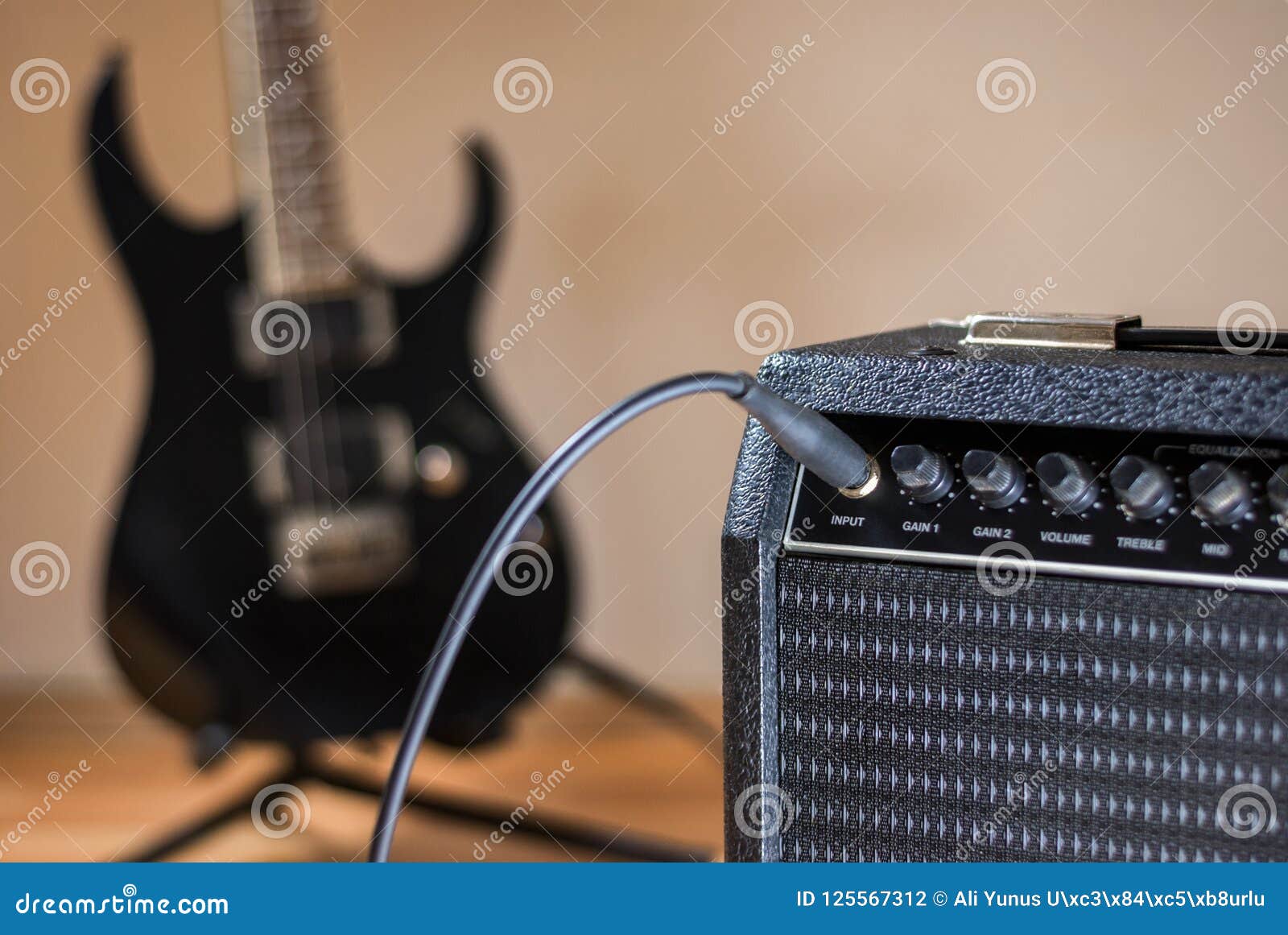 Plugged guitar and amp stock photo. Image of isolated 125567312