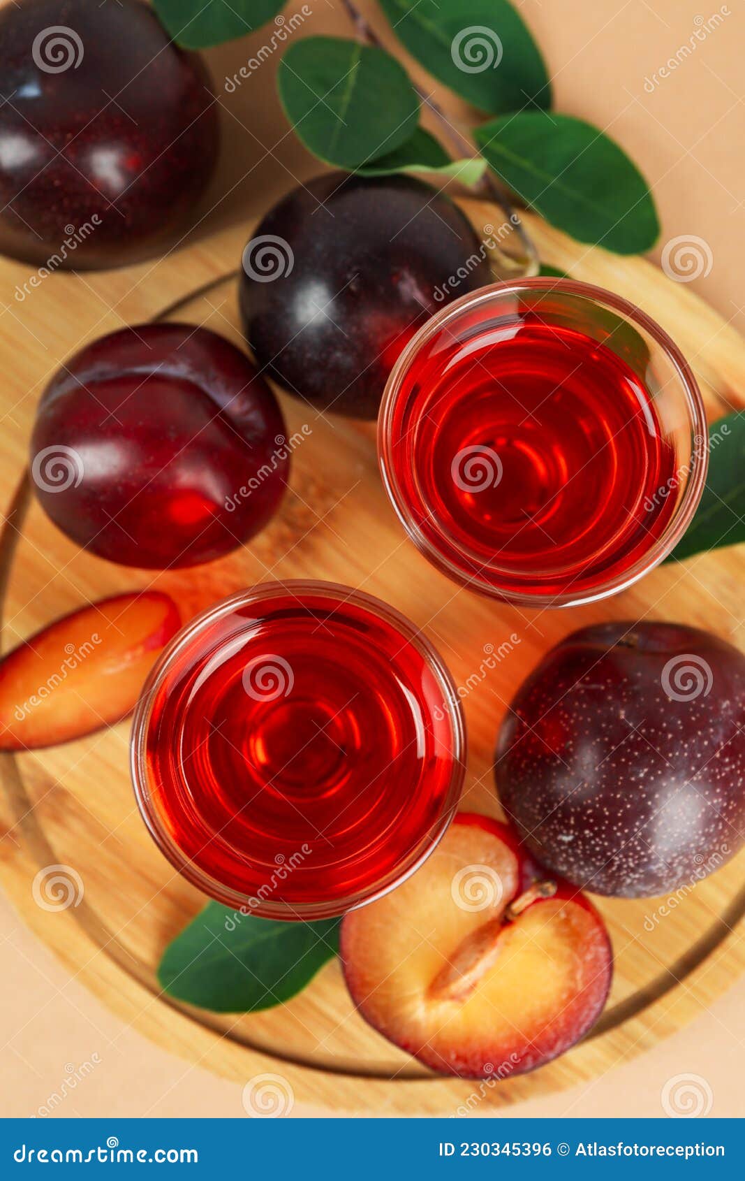 Plum Brandy Shots and Ingredients on Beige Background Stock Photo