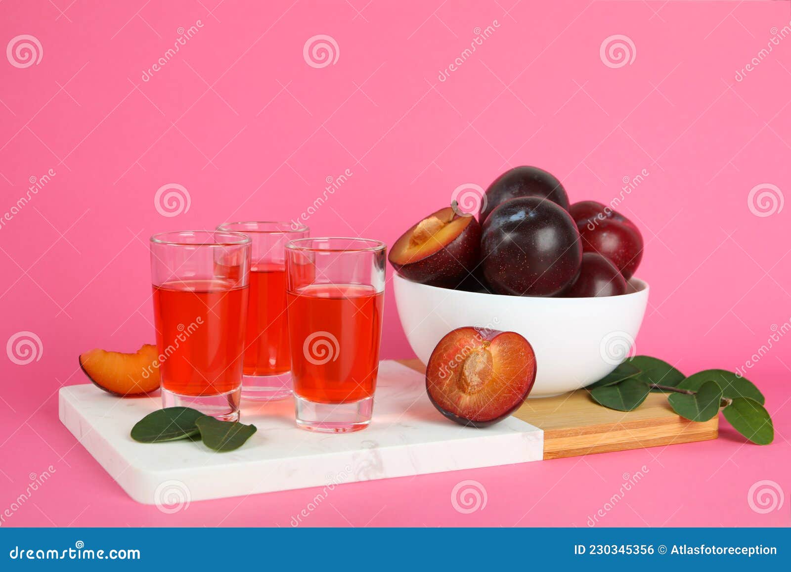 Plum Brandy Shots and Ingredients on Pink Background Stock Photo