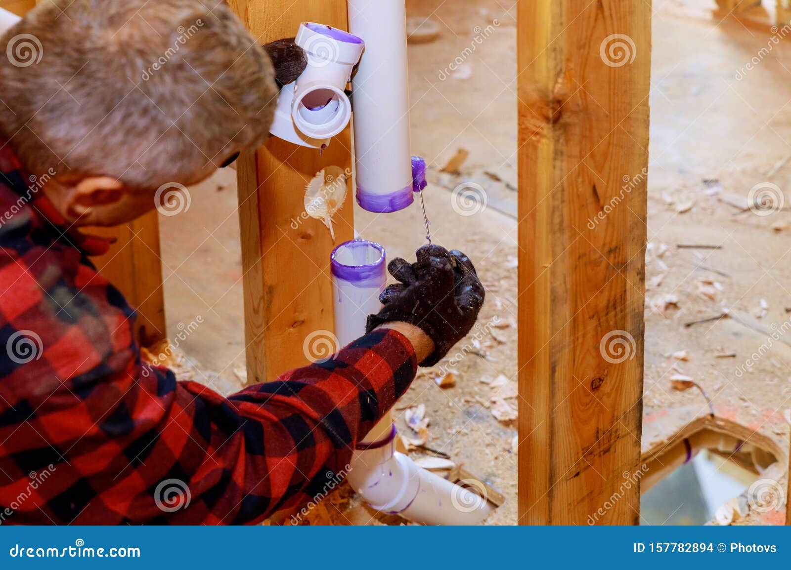 plumber assembling pvc drain pipes