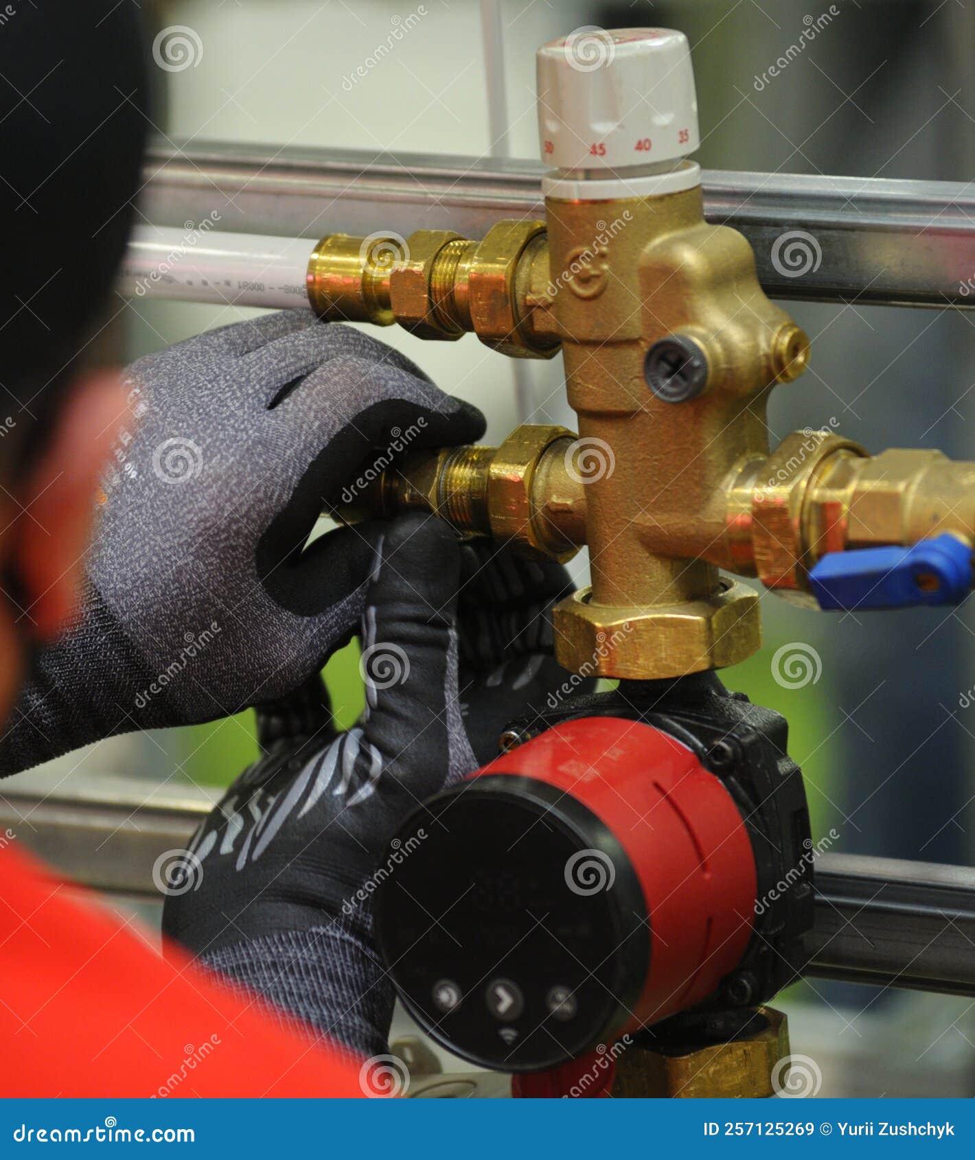 Plumber Hands Installing Circulation Pump for Heating System Stock