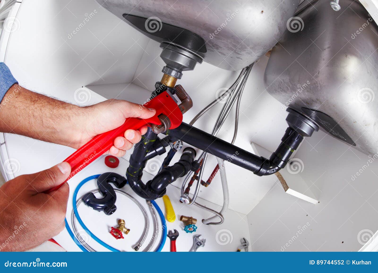 Plumber Hands with a Wrench. Stock Photo Image of manual, background