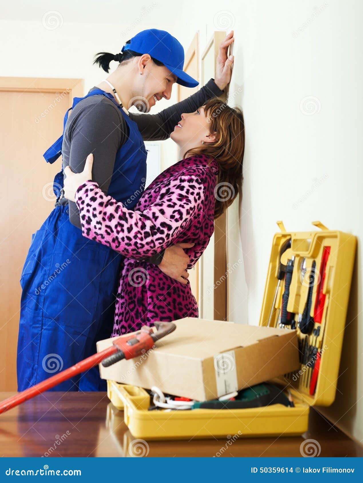 Plumber Having Flirt with Young Girl Stock Photo picture