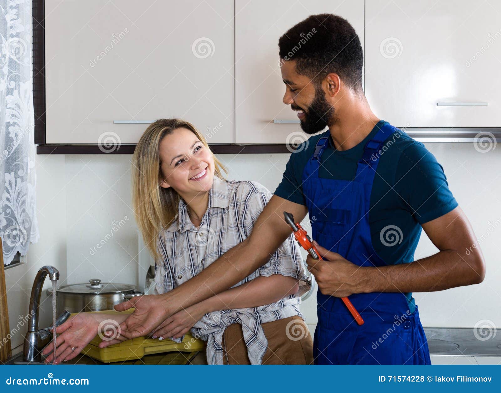 Plumber and Housewife in Kitchen Stoc