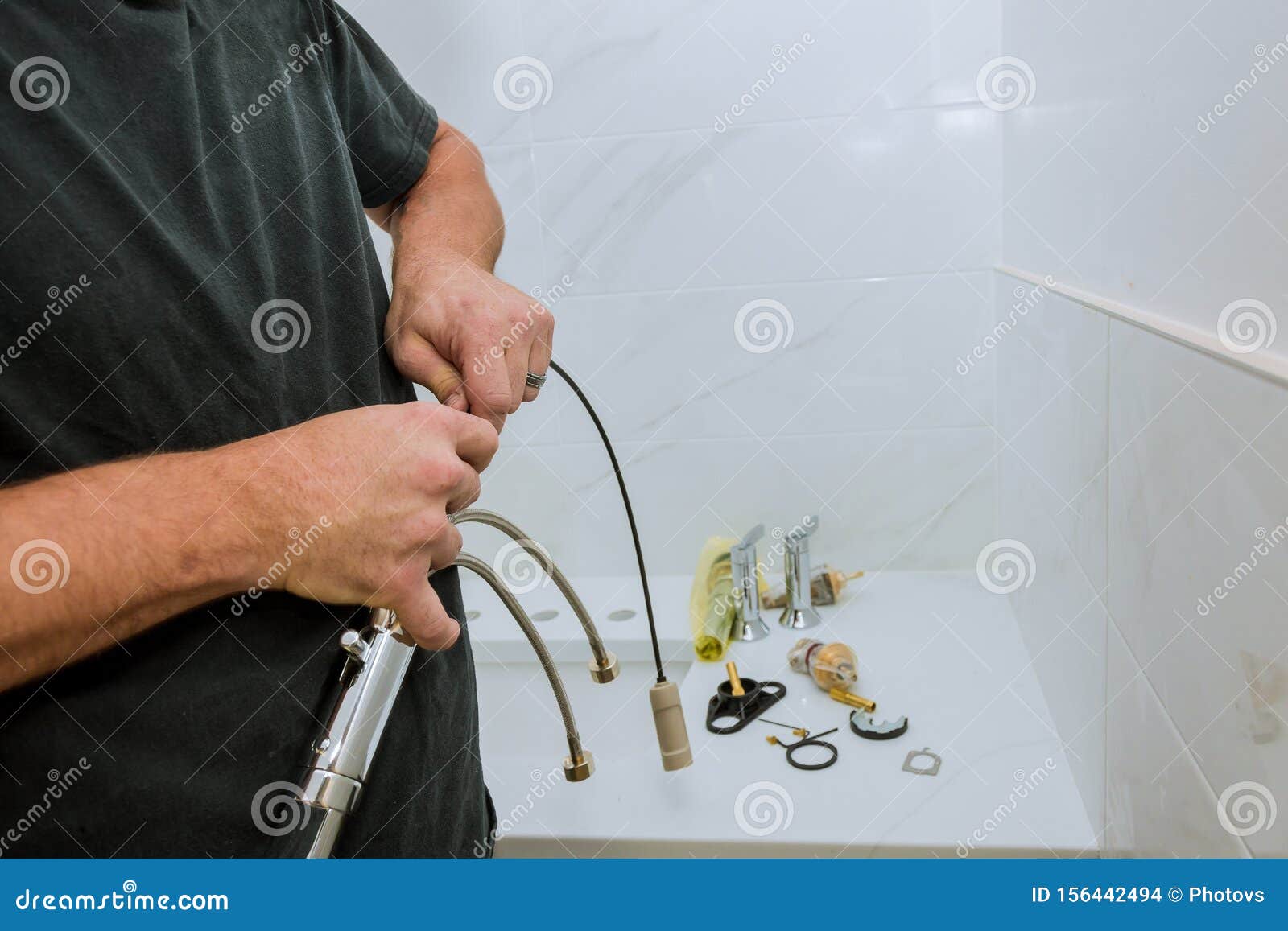 Plumber Installing A Faucet In A Bathroom Only Hands To Assemble