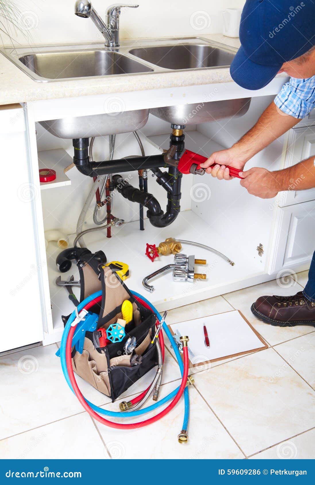 Plumber on the kitchen. stock photo. Image of person 59609286