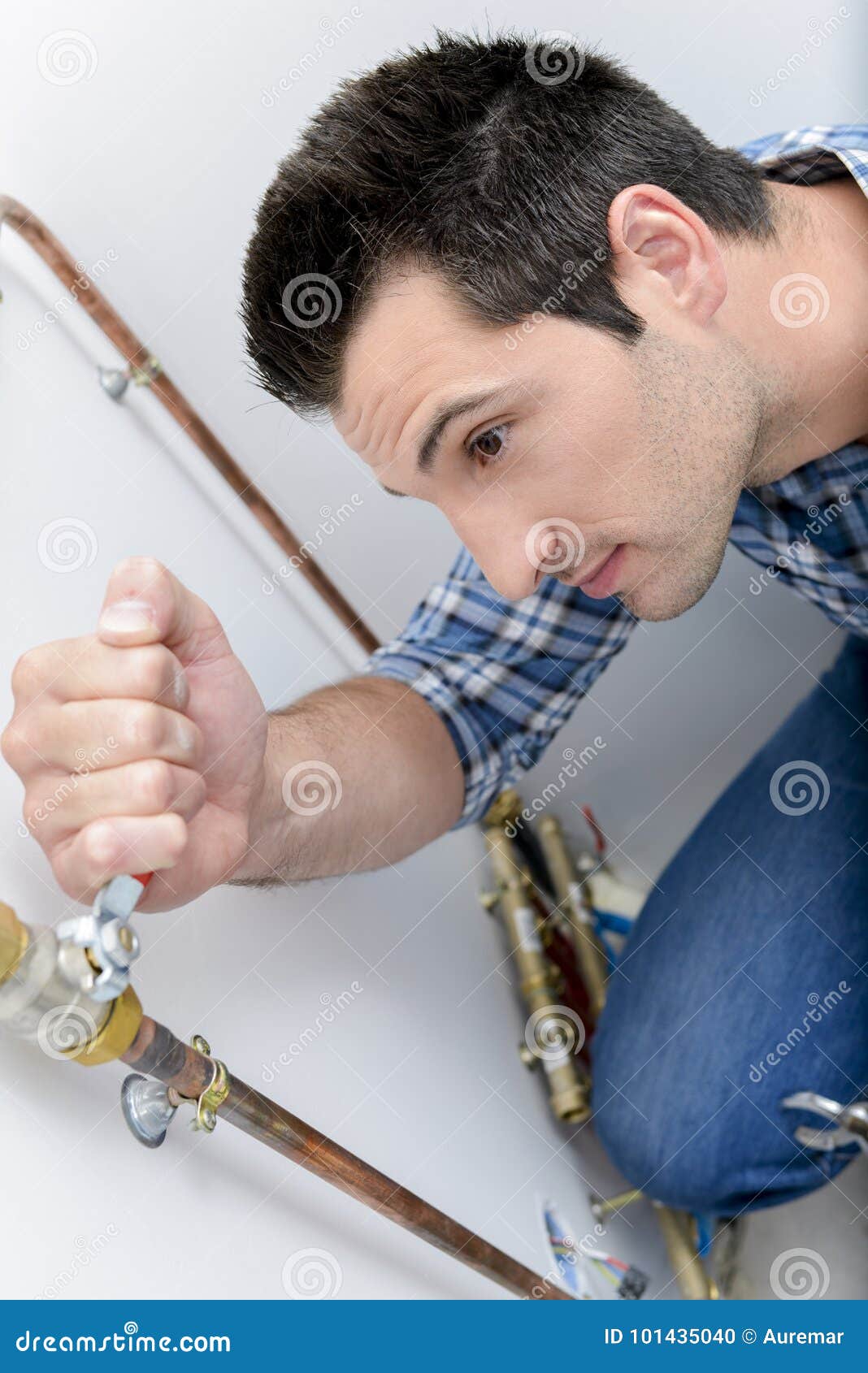 Plumber Making Adjustments To Heating System Stock Photo Image of