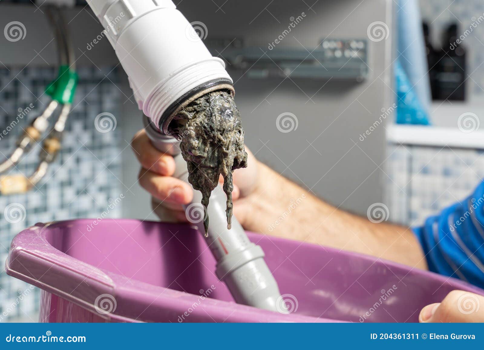 the plumber removes the blockage in the pipes