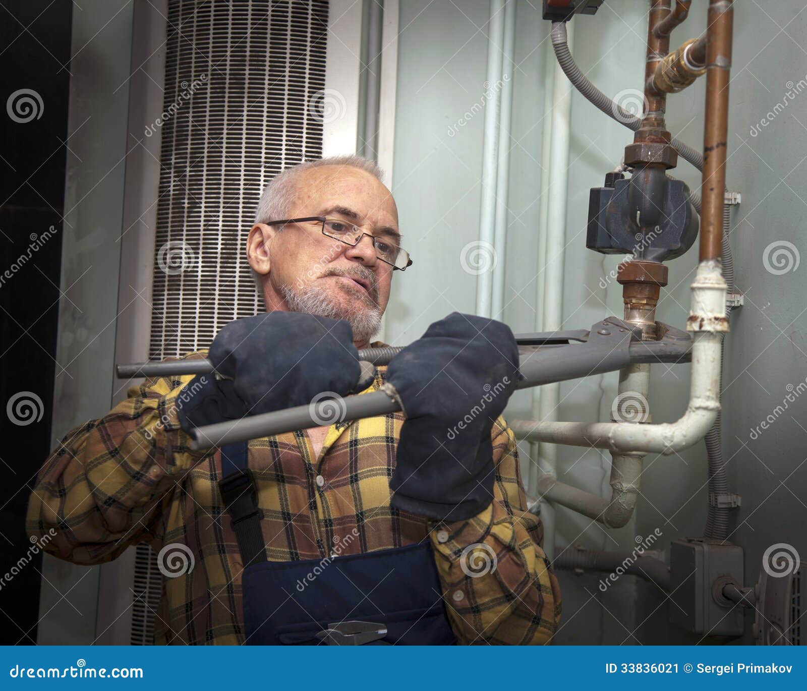 Plumber repairing pipes stock image. Image of device 33836021