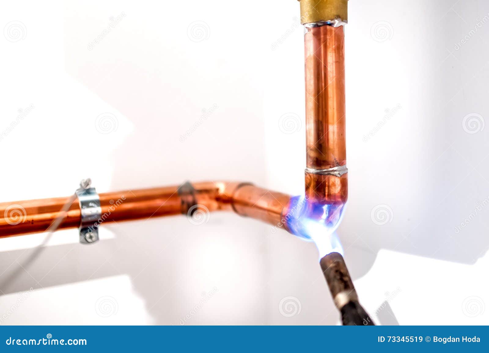 plumber using blowtorch, propane gas torch for welding copper pipes