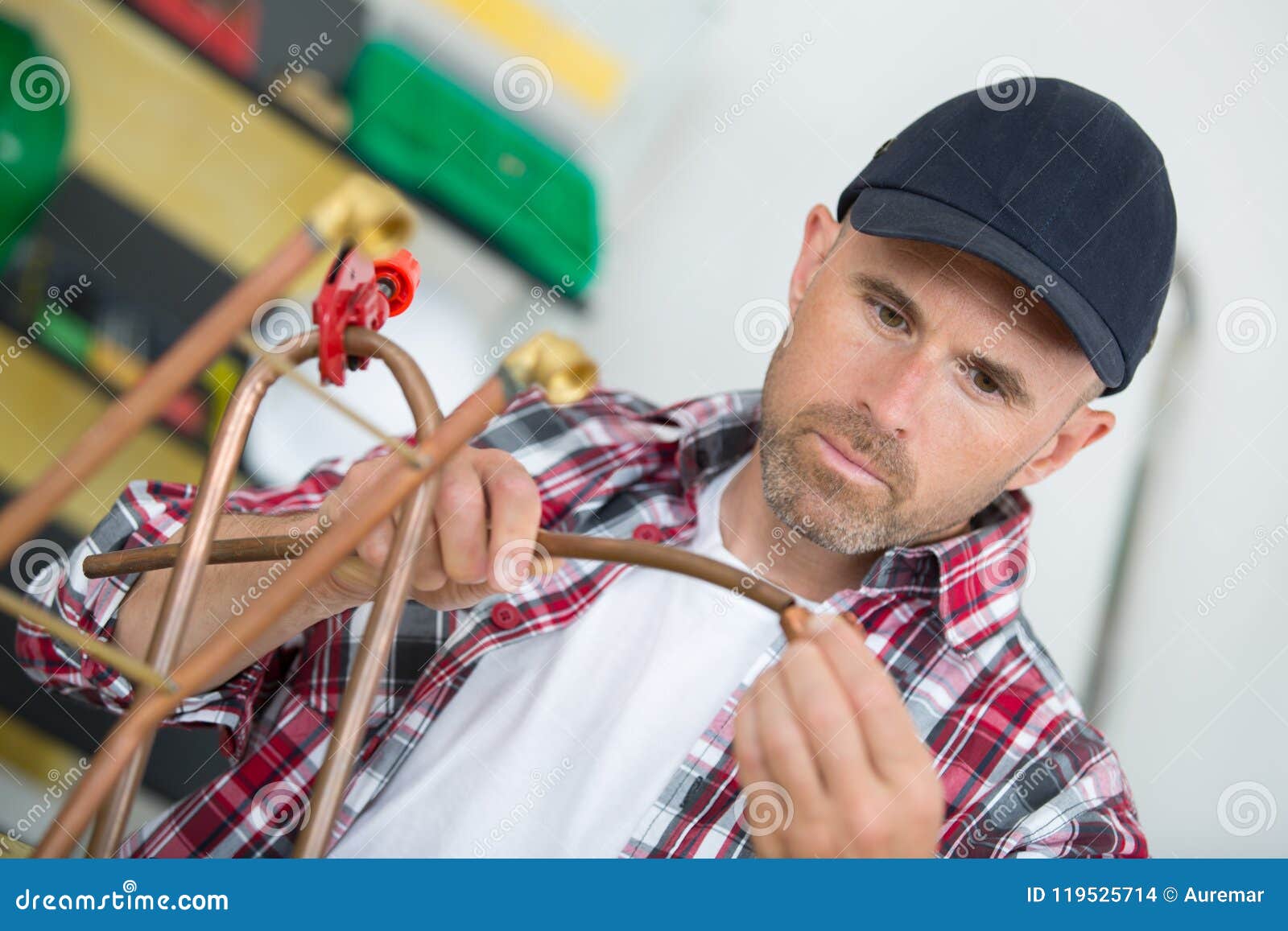 Plumber Using Welding Gas Torch To Solder Copper Pipes Stock Photo