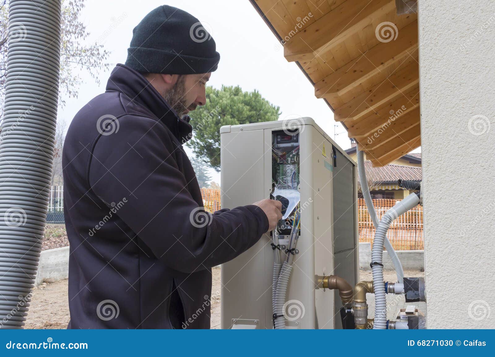Plumber at Work Installing a Heat Pump Stock Photo Image of
