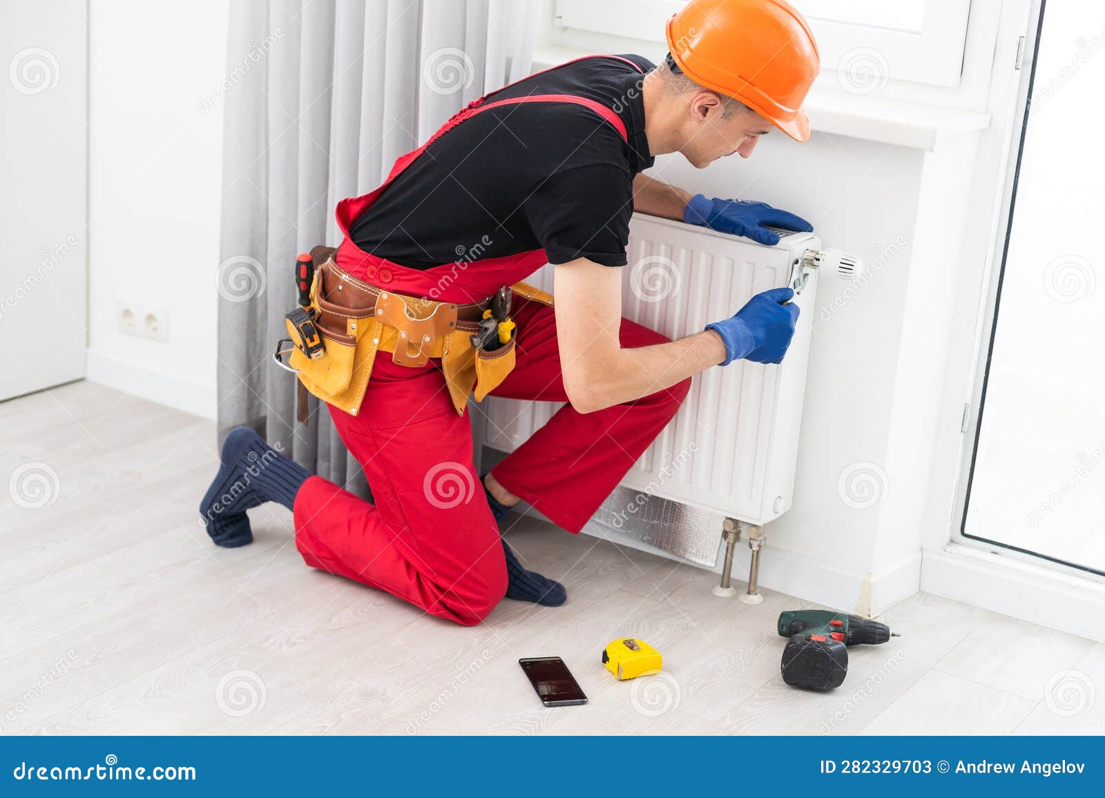 Plumber at Work Installing Water Heating Radiator Stock Image Image