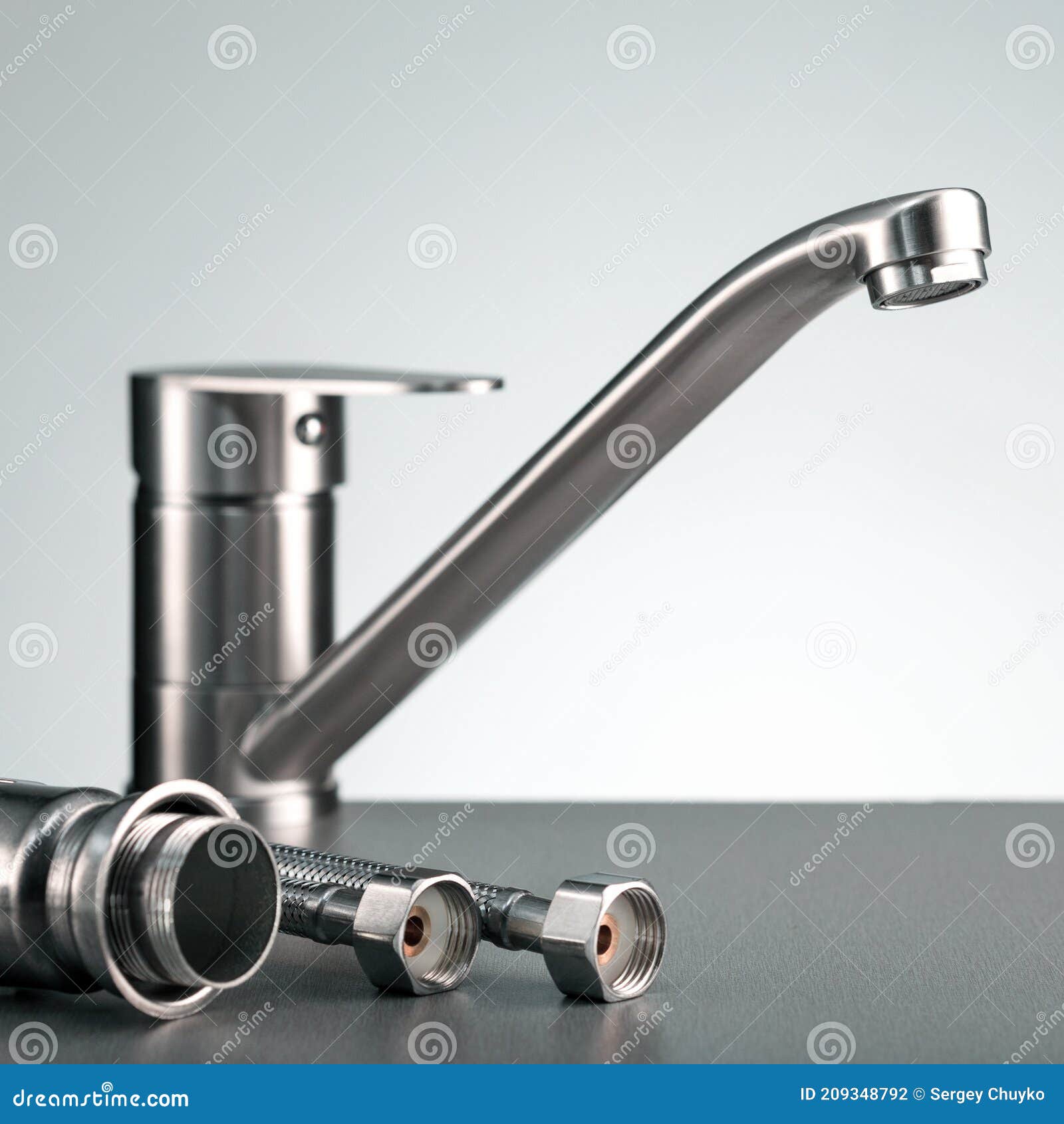 Plumbing Concept with Faucet Over Gray Background. Stock Photo Image