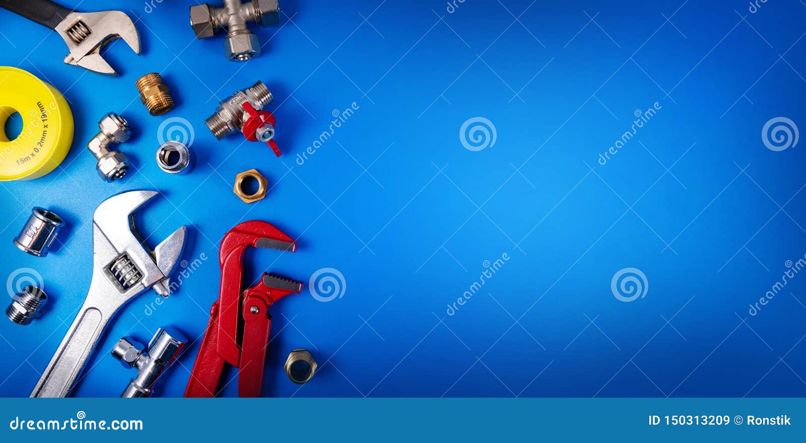 plumbing tools and fittings on blue background with copy space