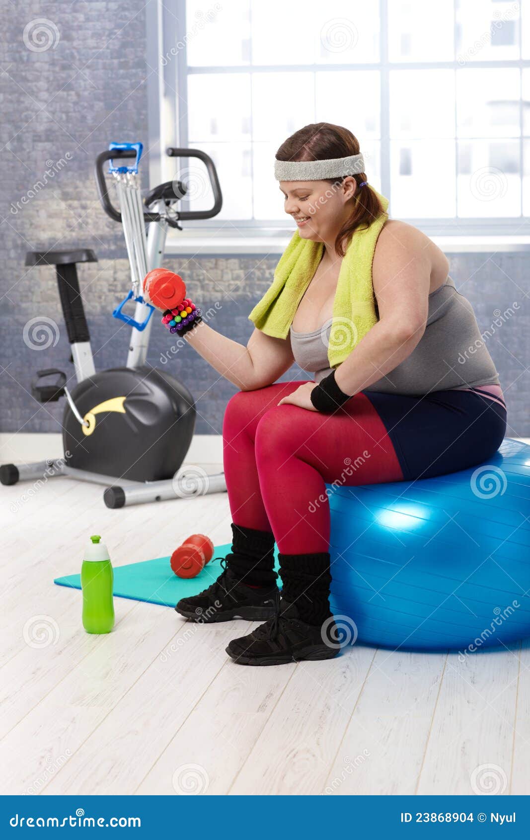 plump woman exercising with dumbbells