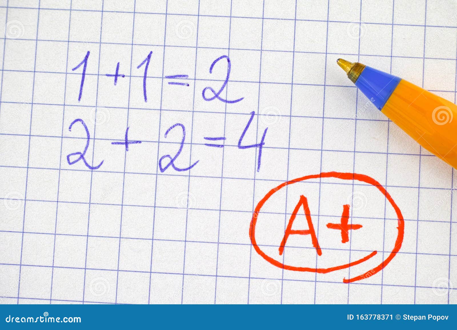 A Plus a+ Grade on Notebook Paper Sheet with Math Operation Solved