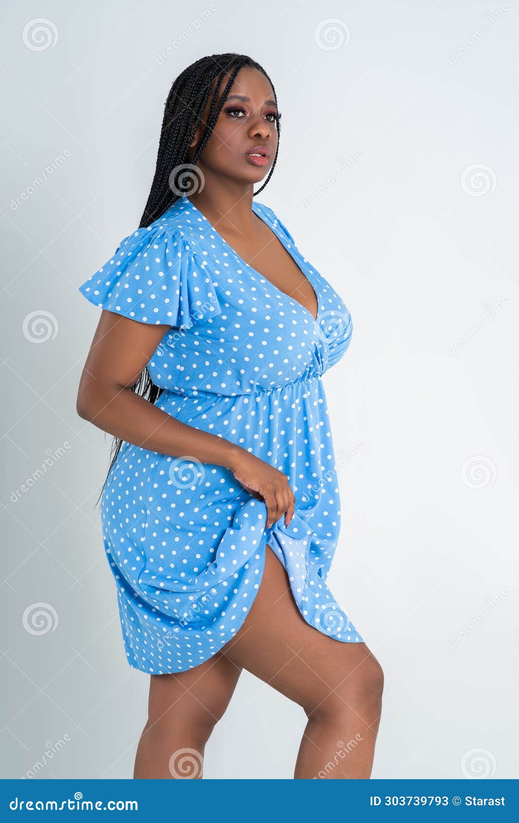 Plus Size Female Model Posing in Blue Dress on White Background