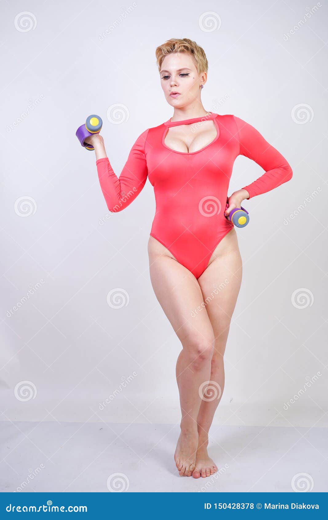 Plus Size Girl with Short Hair and Big Breasts in Red Spandex Sports Doing Exercises with Purple Dumbbells on White Backg Stock Photo - Image isolated, athletic: 150428378