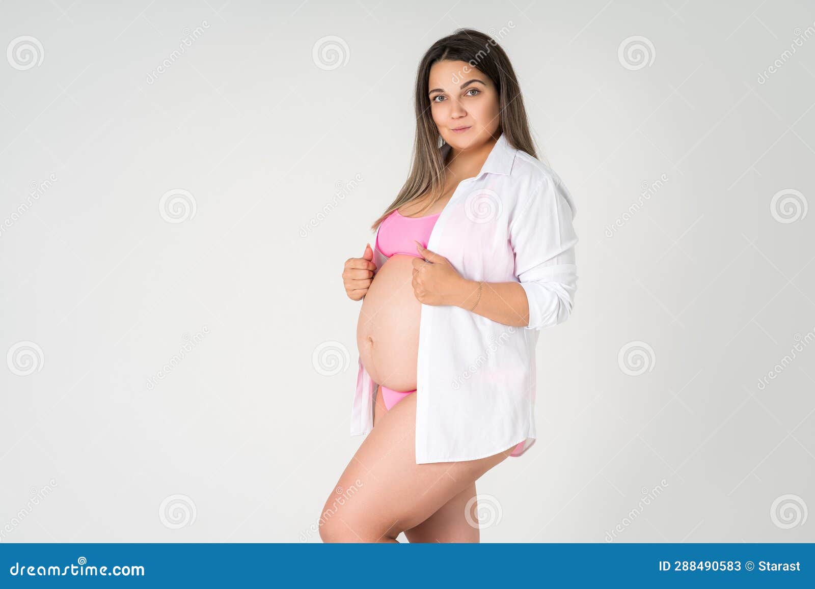 Back view of a happy plus size woman wearing underwear in a studio
