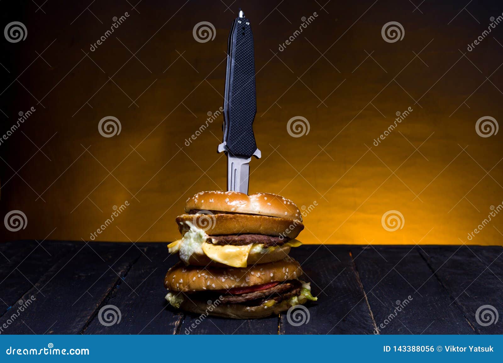 a pocket knife in a burger. folding knife and burger