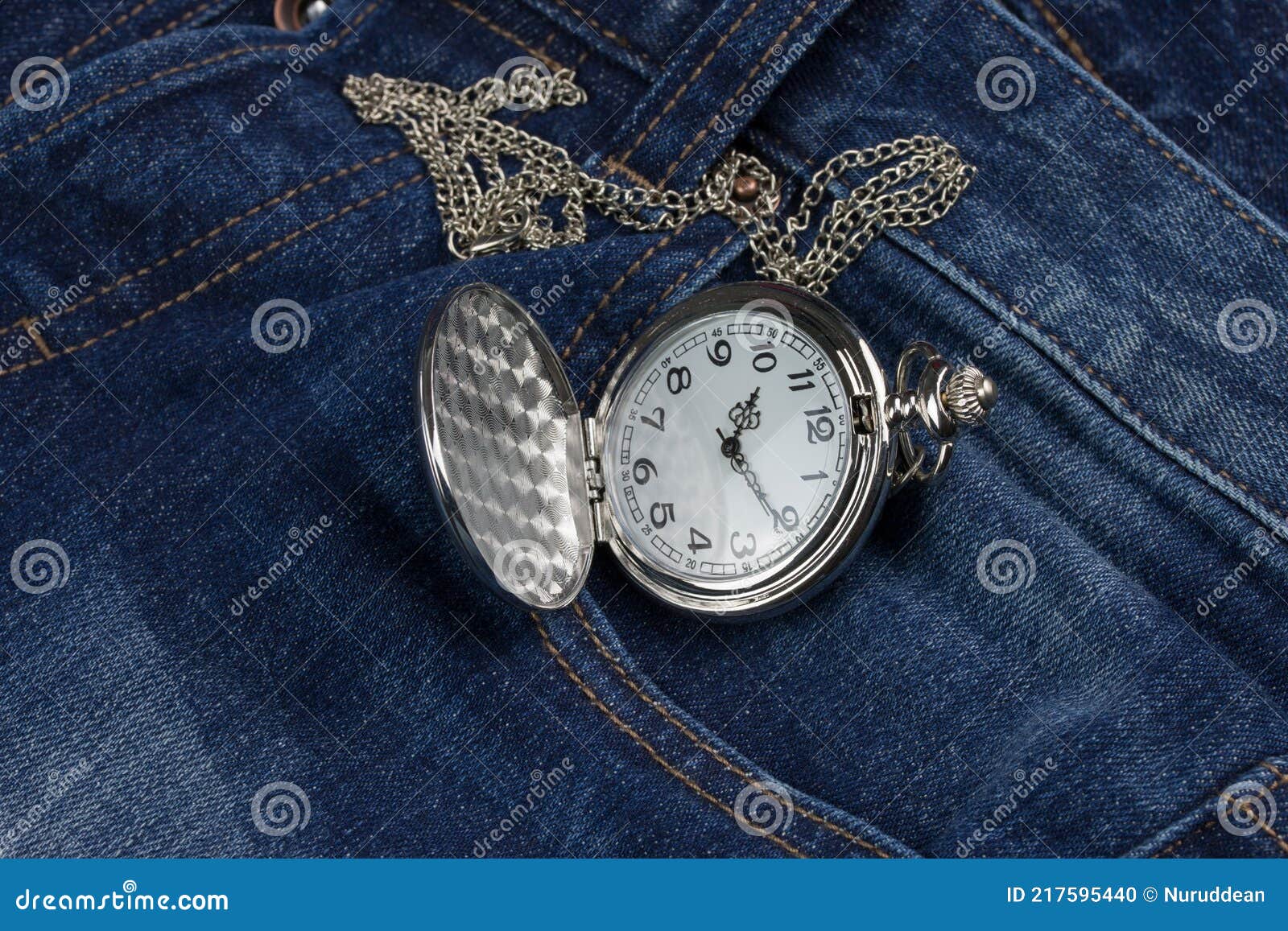Pocket watch on blue jeans stock photo. Image of closeup 217595440
