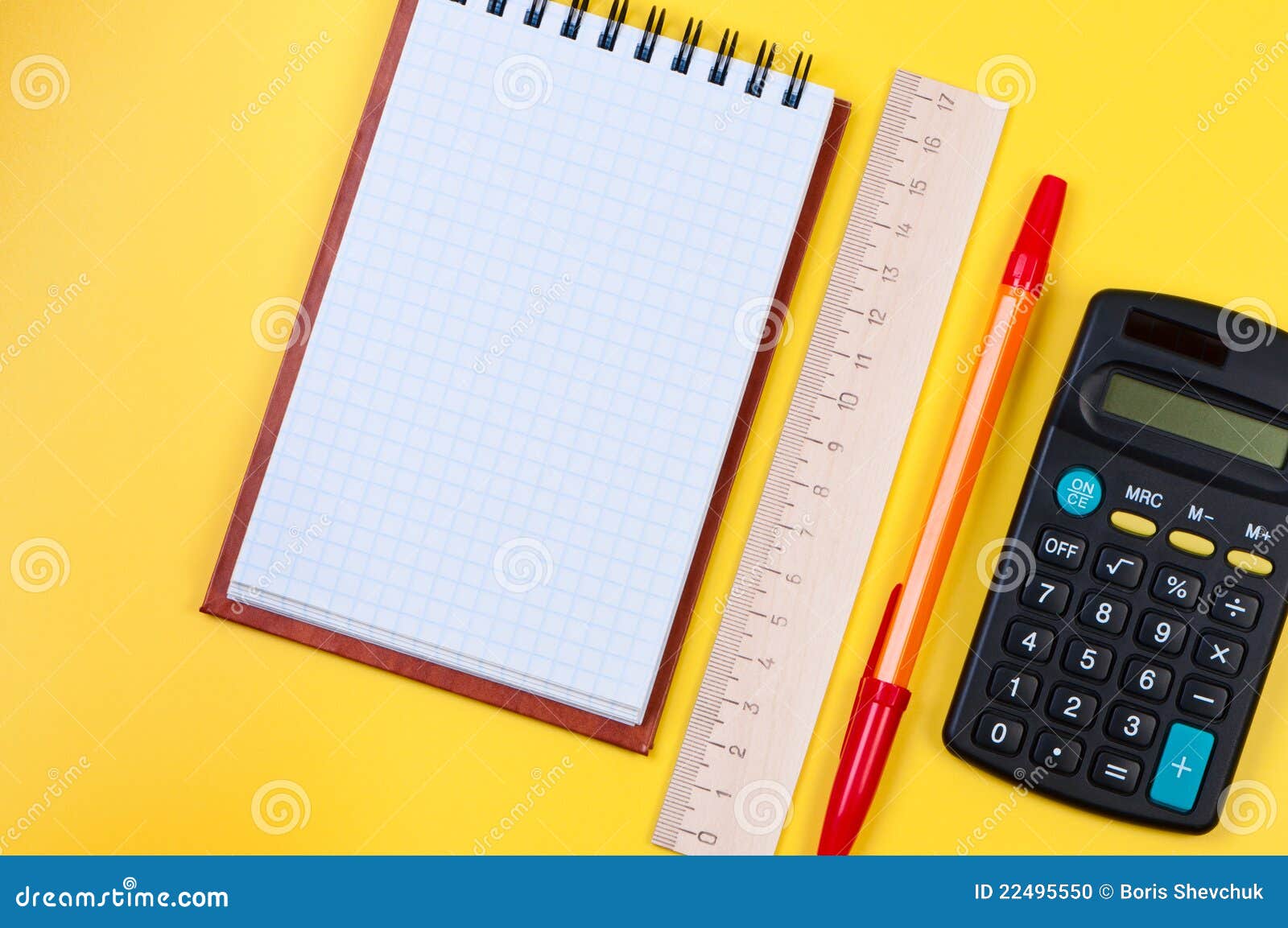 pocketbook and calculator on yellow background.