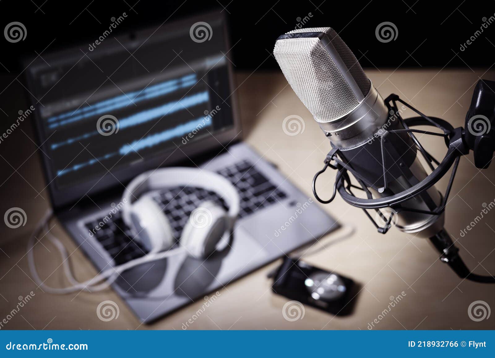 podcast microphone and laptop computer in recording studio