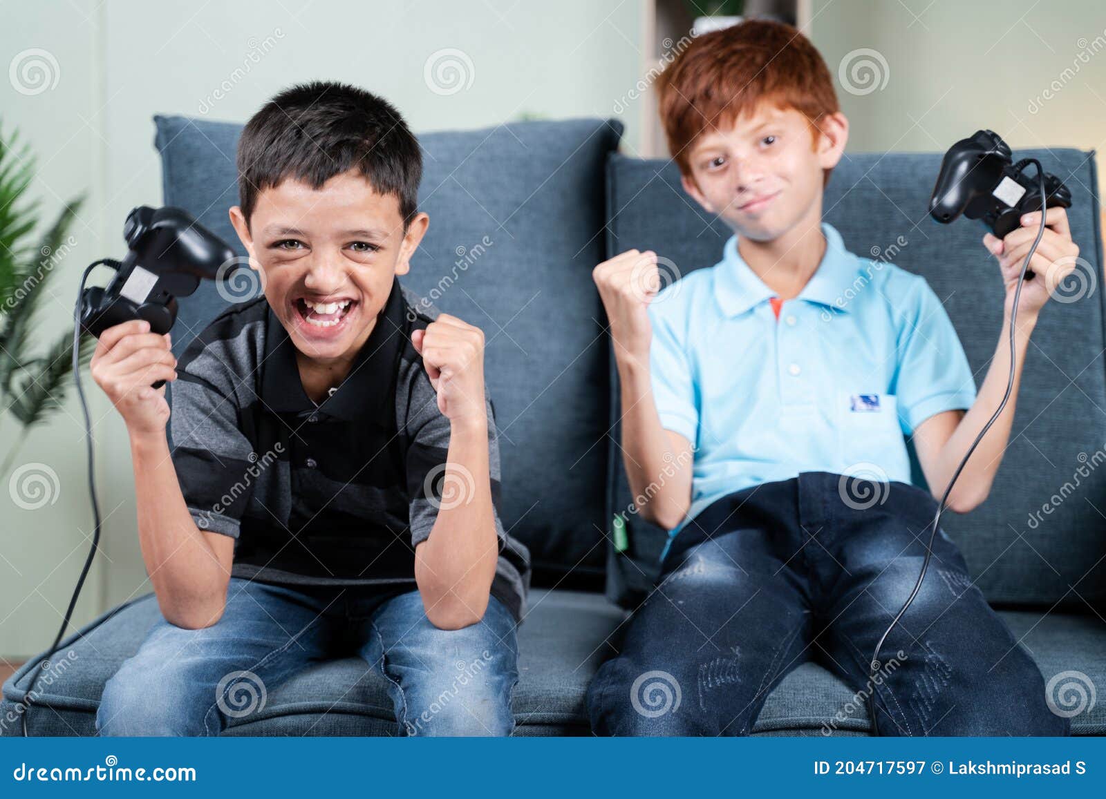 Point of View Shot, Two Kids Cheering and Shouting after Won the Online Video Game Match while Playing with Joystick or Gamepad at Stock Image