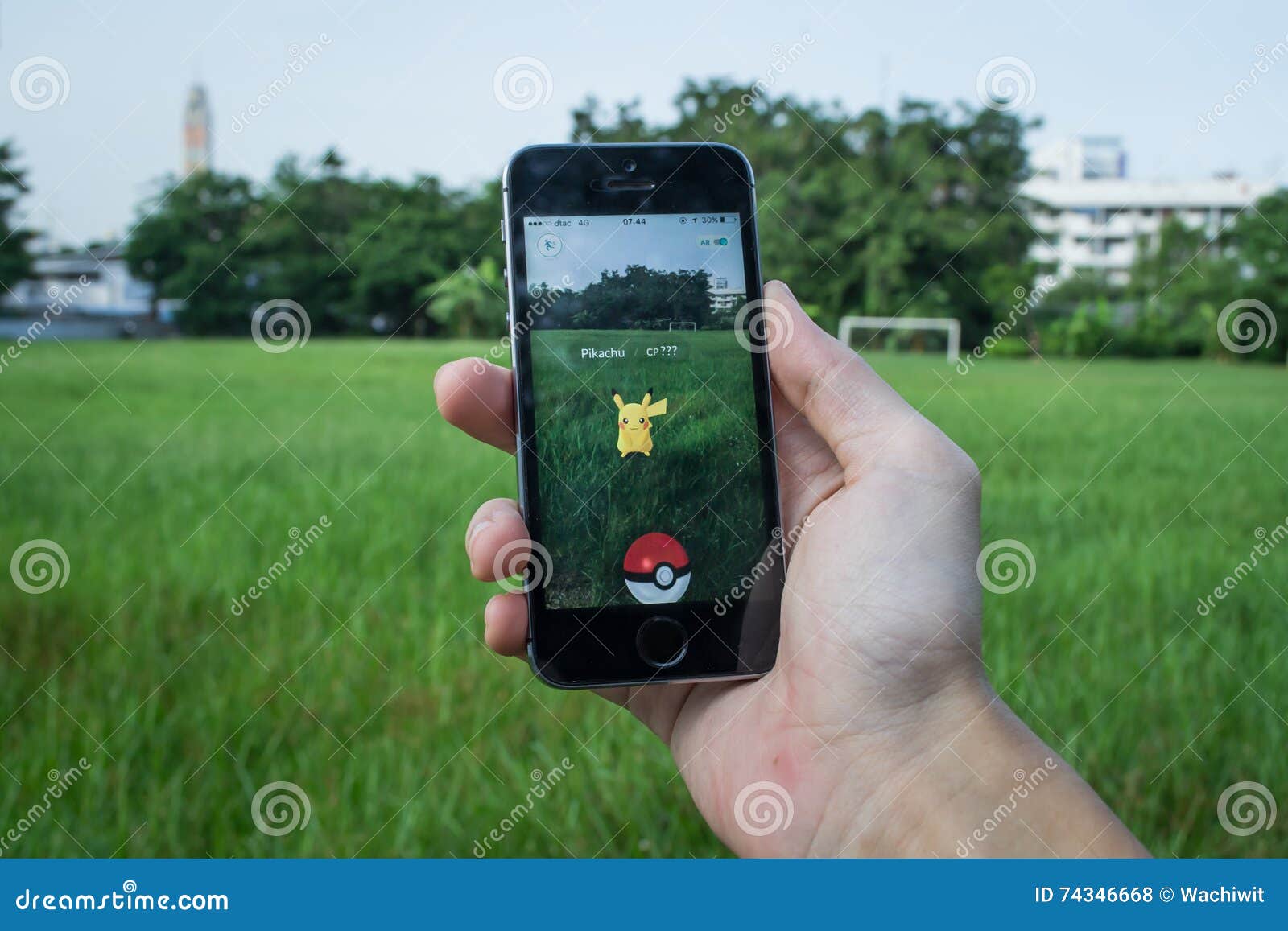 Royalty-Free photo: Person holds smartphone with Pokemon Go application  running