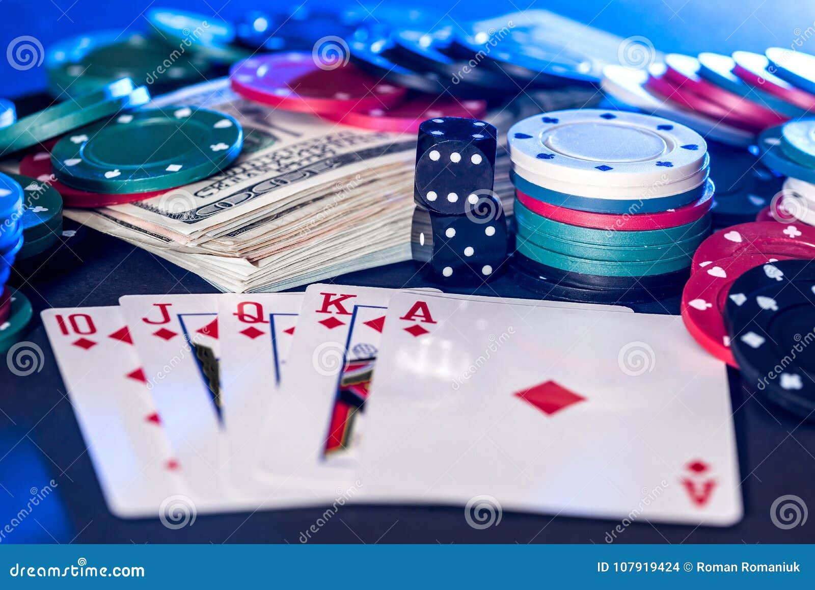 Black background with poker chips, cards, dollars and bones