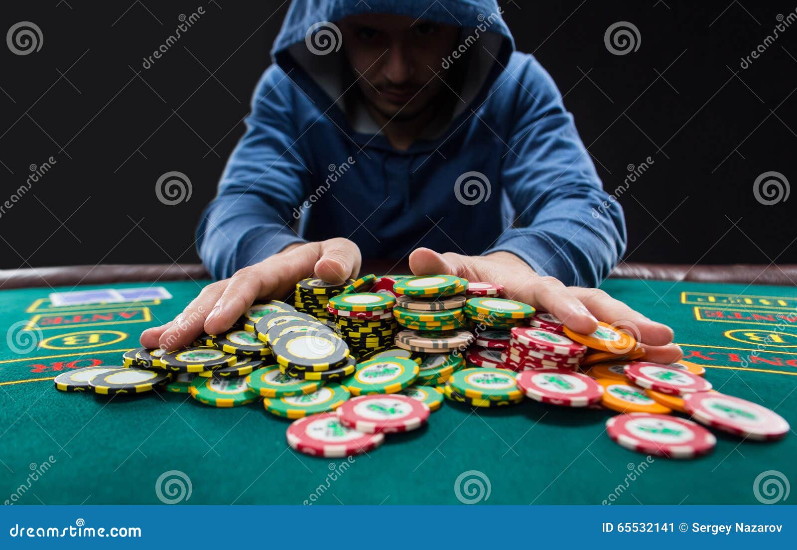 poker player going all in pushing his chips forward