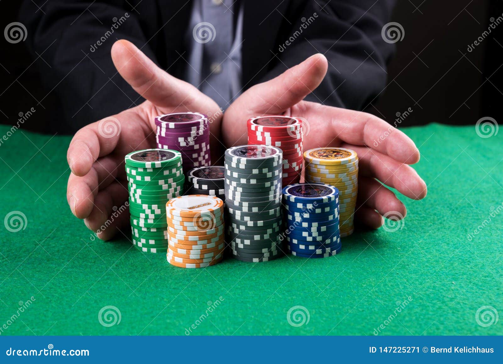 Poker Player Going `all in` Pushing His Chips Forward Stock Image