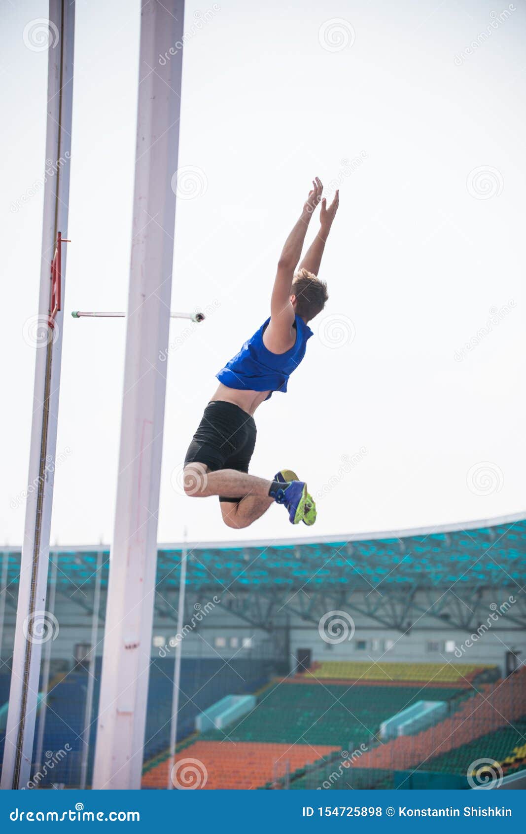Pole Vault a Young Athletic Man Falling Down on the Mat after Jumping