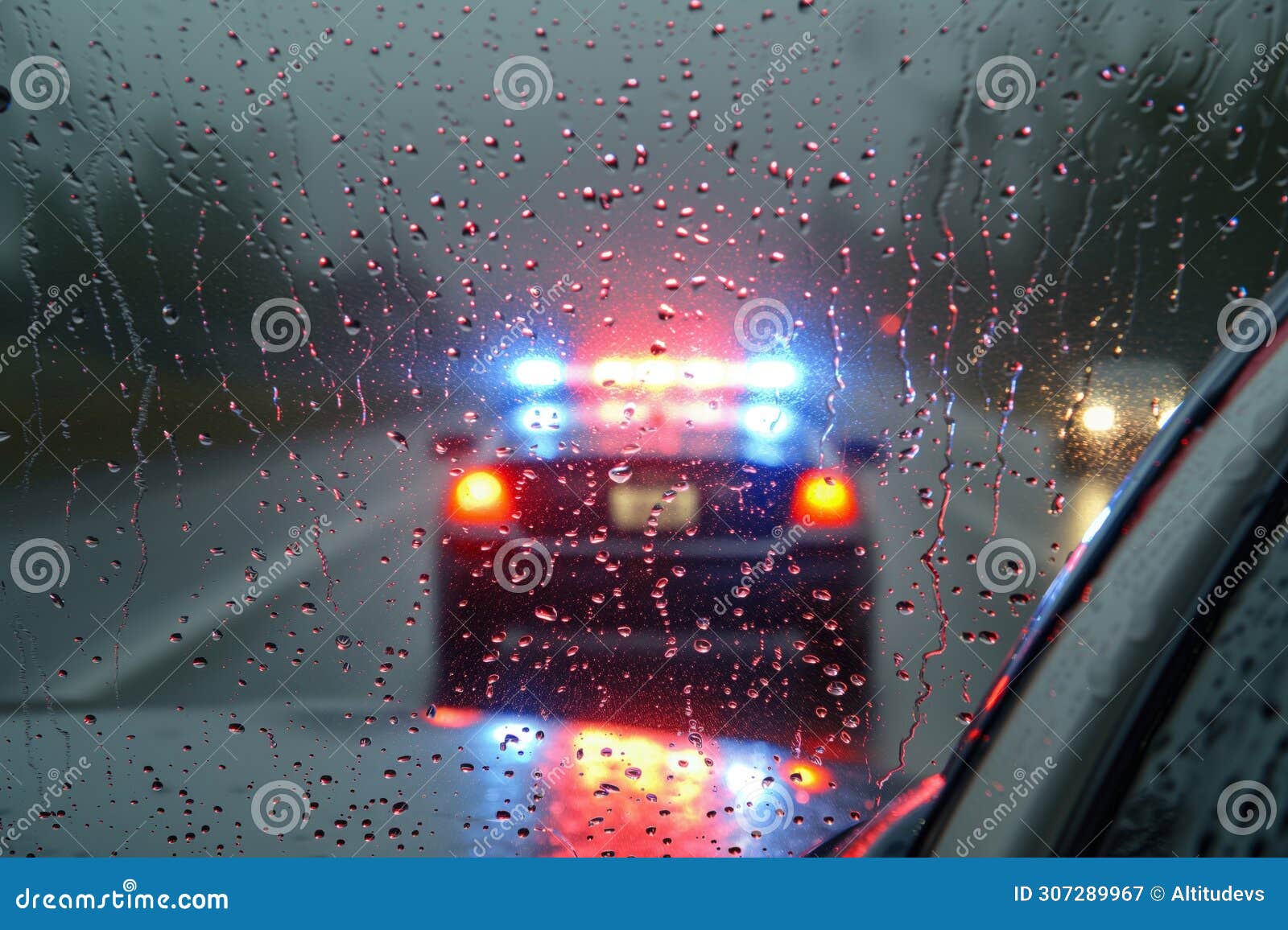 police car with strobes on, seen through a rainsoaked window