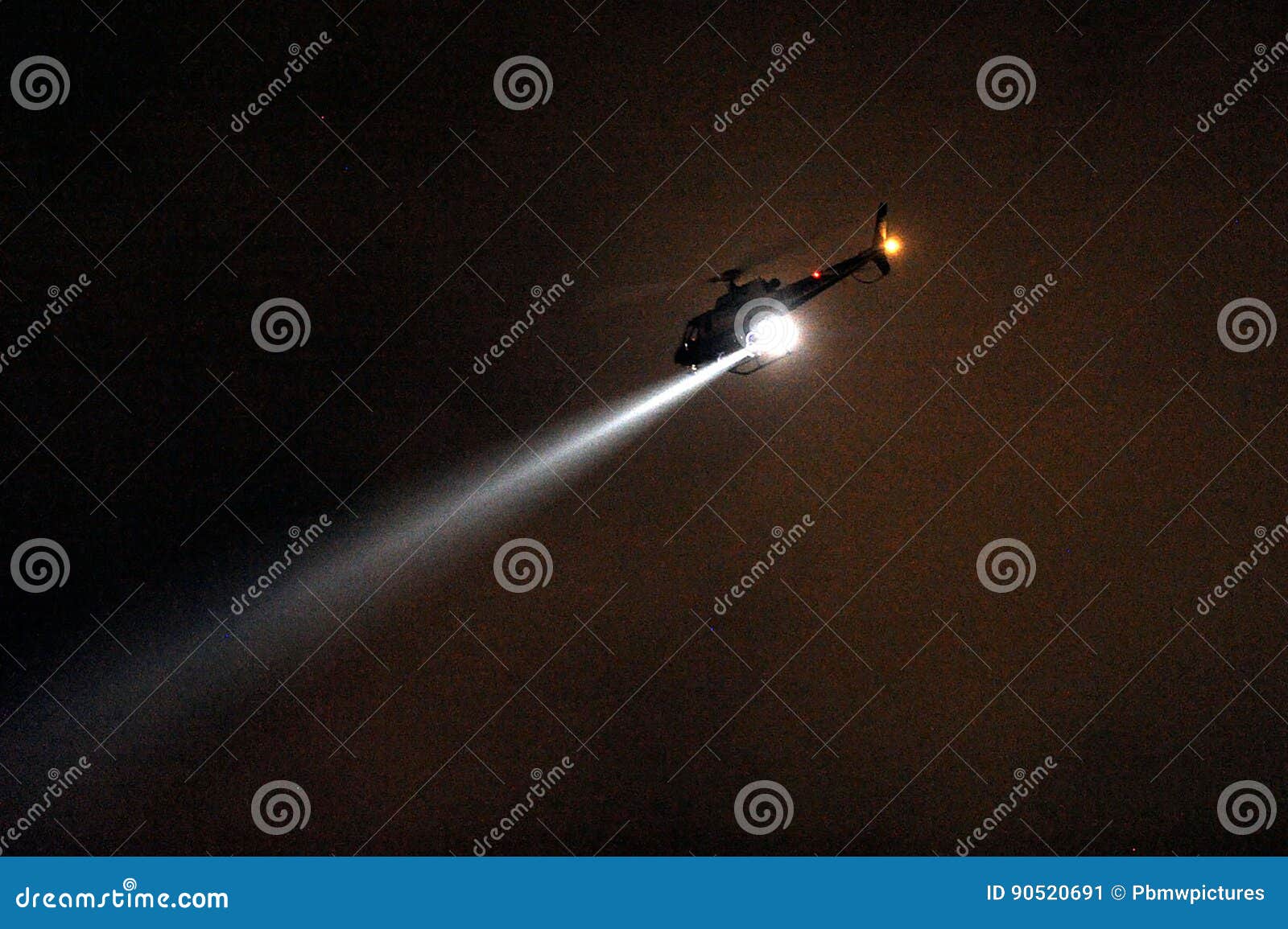 police helicopter with searchlight at night