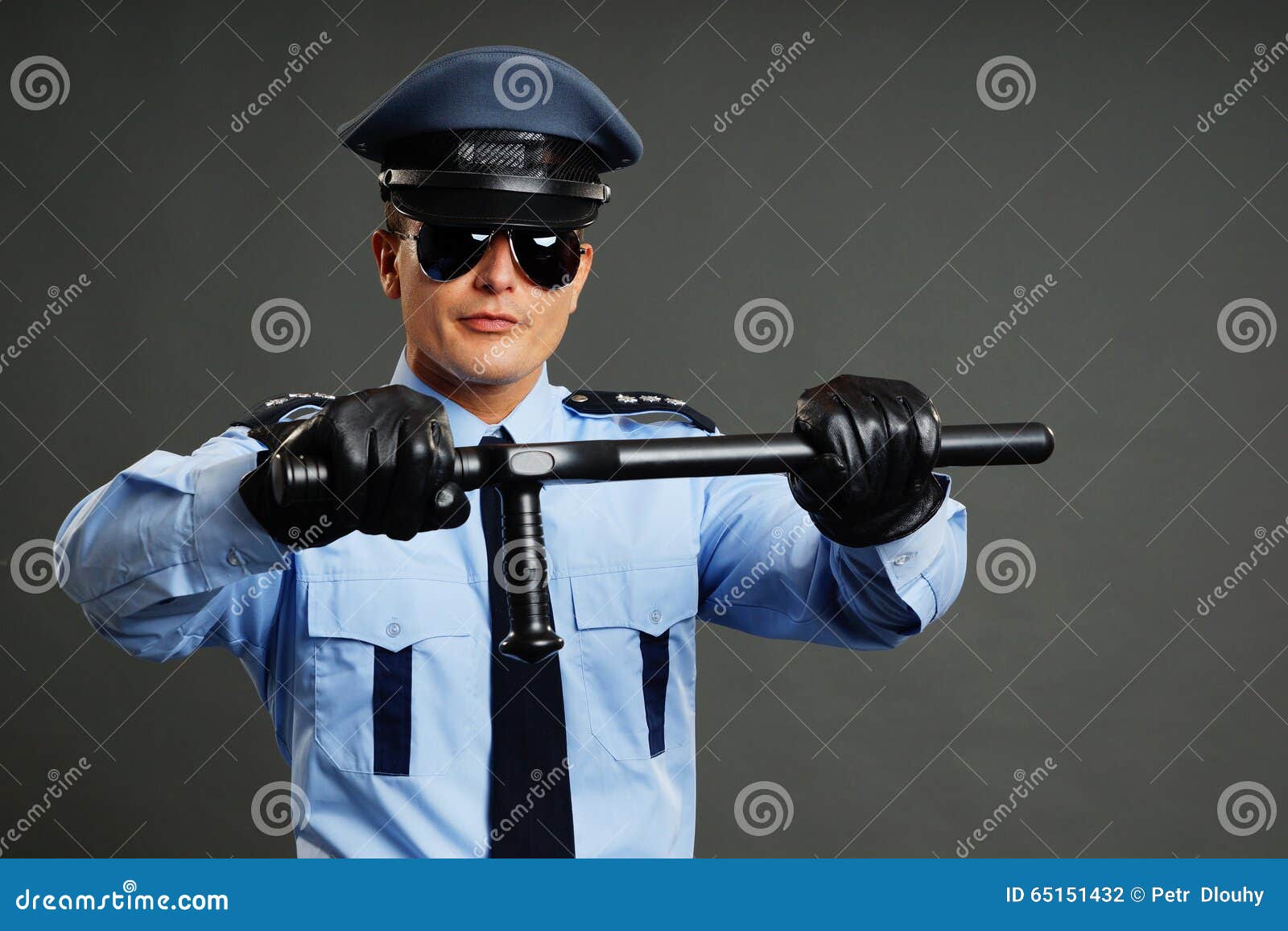 Policeman holds nightstick stock photo. Image of safety 65151432