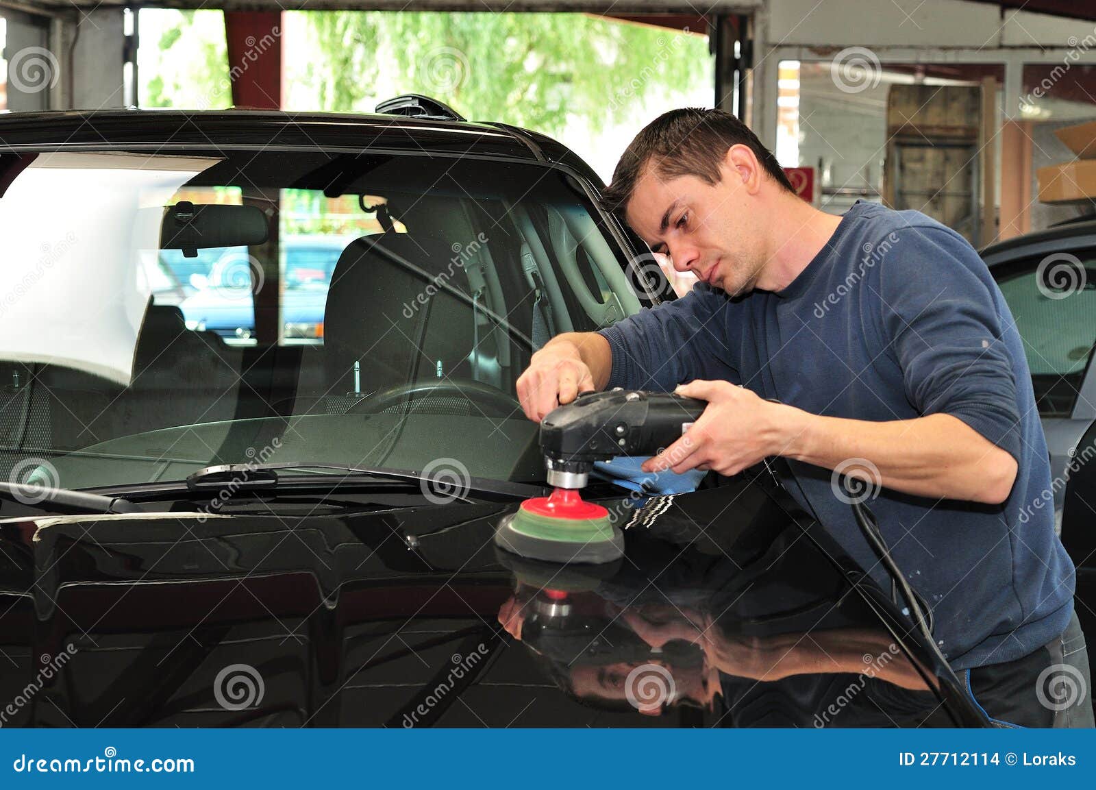 polishing a car.