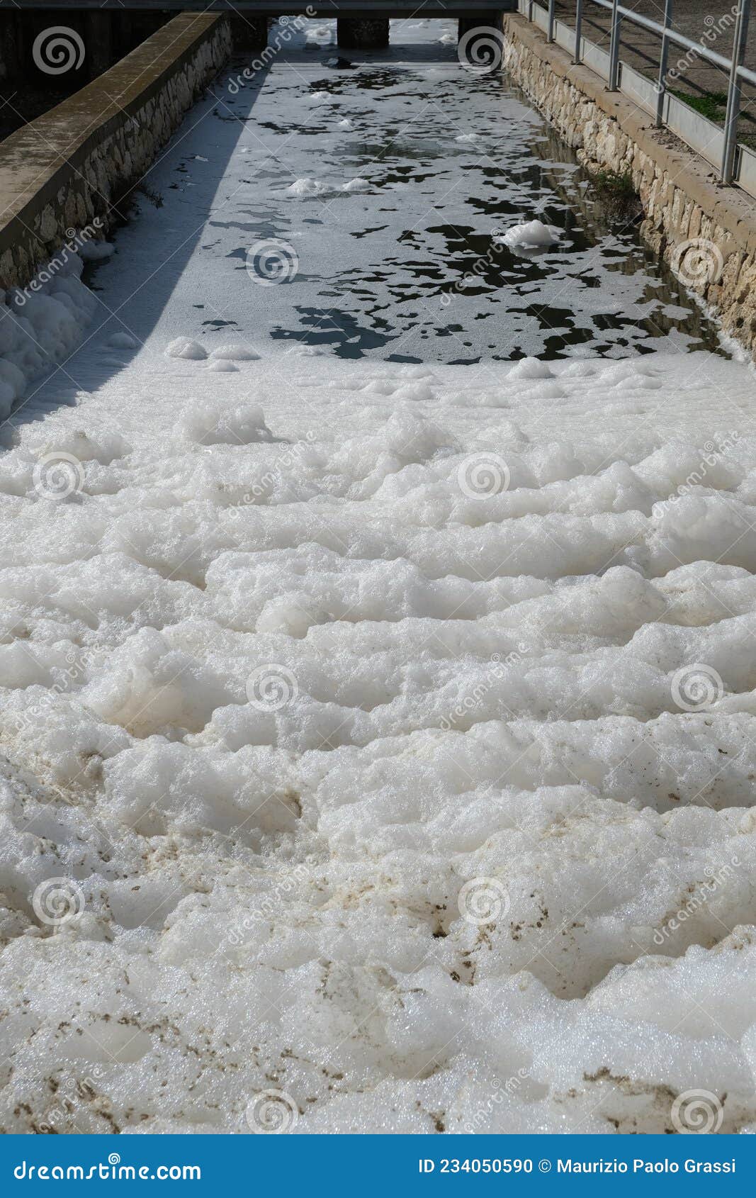 pollution of a channel caused by surfactants. white foam in a stream kills life