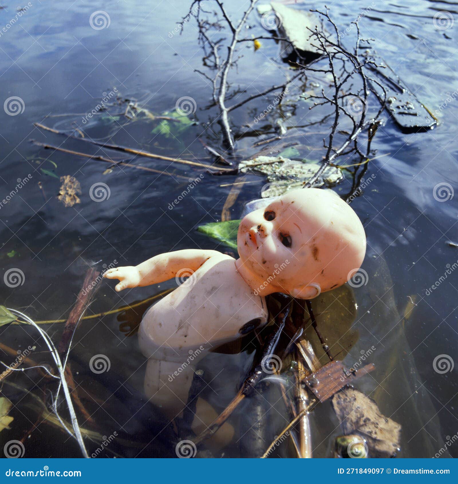 pollution in public water by a discard,plastic toy doll