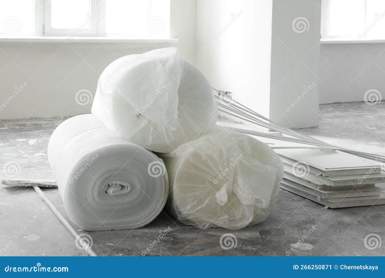 Polyethylene Foam Rolls on Floor Near Windows in Room Stock Image