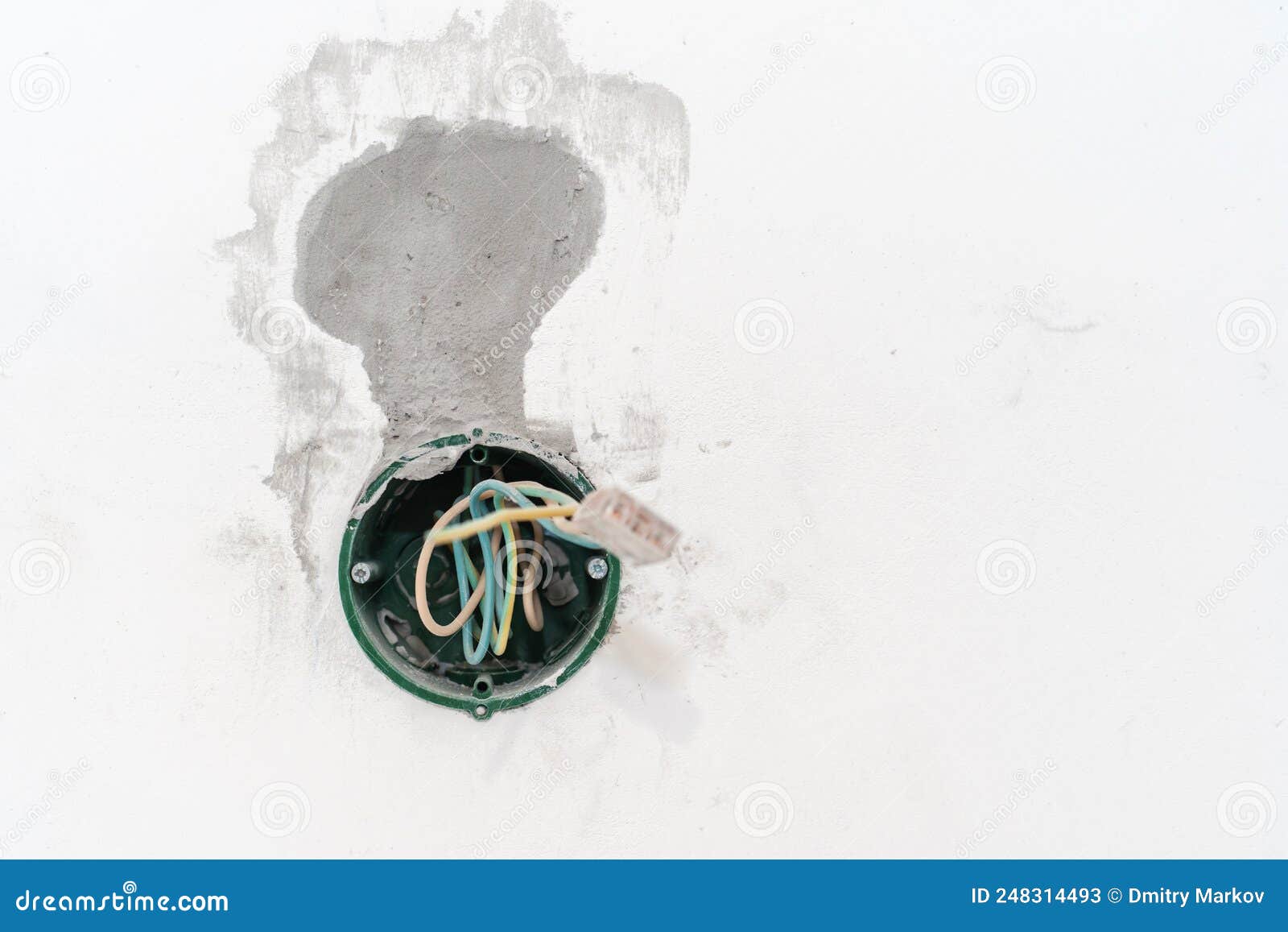 Polymer Socket in a Concrete Wall. Installation of Electrical Wiring in