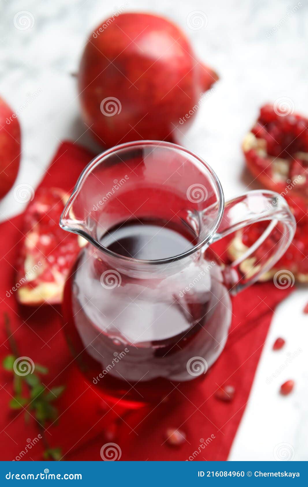 Pomegranate Juice in Jug and Fresh Fruits on White Table Stock Photo