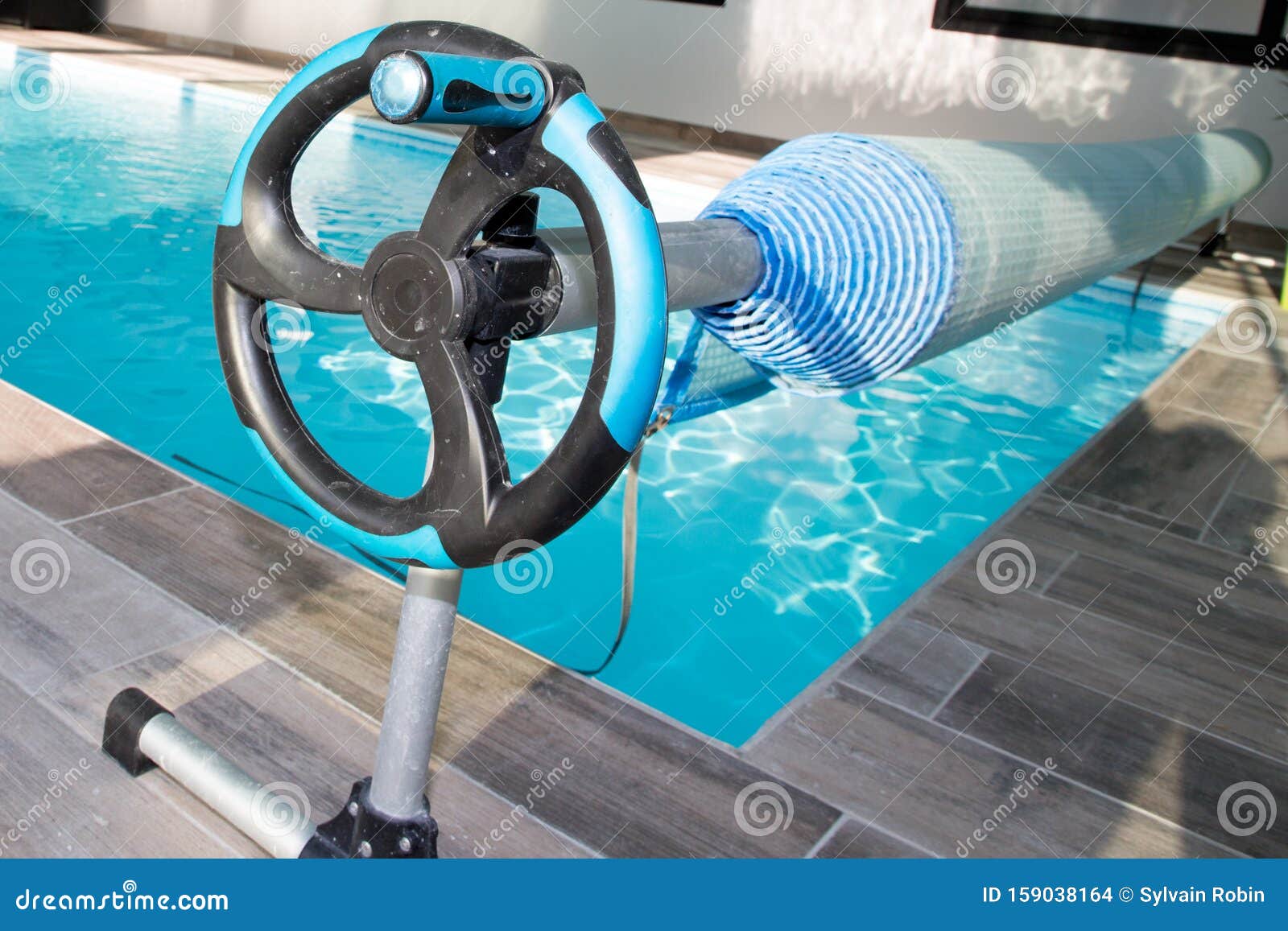 Pool Bubble Cover Rolled Up on a Roller Stock Photo Image of